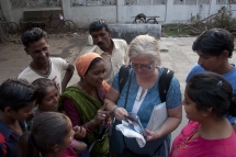 Distributing photos in slum